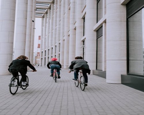 Group of people cycling together in the city during daytime
